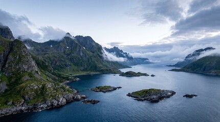 Obraz premium Fjord Landscape: Majestic mountains rise from a tranquil fjord, with small islands dotting the serene water under a dramatic, cloud-filled sky.