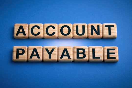Account payable phrase written on wooden letter tiles on a blue background