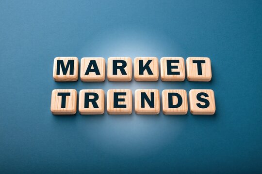 Market trends text elegantly formed with wooden letter tiles on a blue background