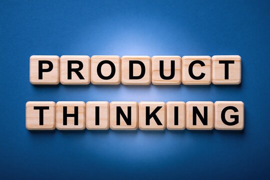 Product thinking text formed by wooden letter blocks on a blue background