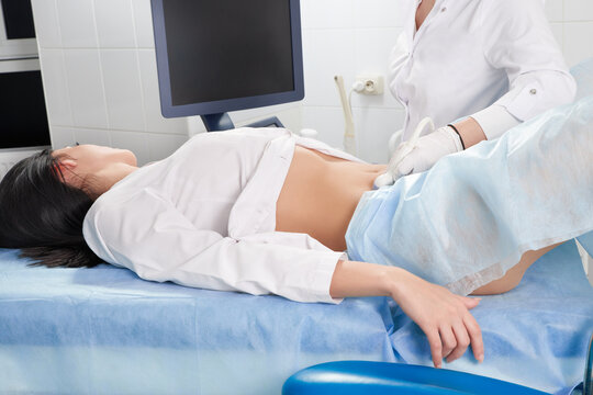 Gynecologist doing ultrasound scanning for pregnant woman