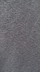 Dark gray fleece fabric texture with a soft fuzzy knit surface © Jus