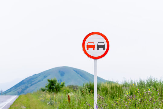 Road sign prohibiting the overtaking of a car