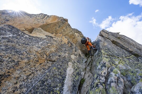 Mountaineers on steep rock face in the secured via ferrata Crocodile Mountain Lake at Bergseeschijen-Vorbau, Sonnenstern, G&ouml;scheneralp, Canton of Uri, Switzerland