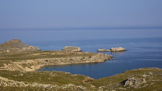 Rocky coastal landscape with small islands and clear blue water, Lindos, Rhodes, Dodecanese, Greek Islands, Greece