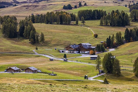 Hotel Ritsch in the middle of autumnal alpine meadows on the Alpe di Siusi, Val Gardena, Dolomites, South Tyrol, Italy