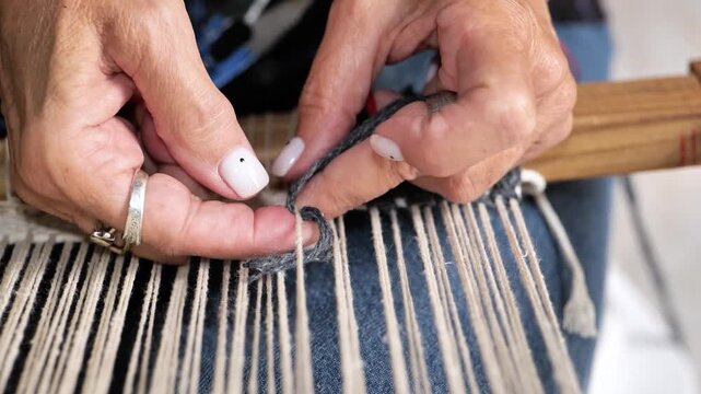 Woman's hands knitting with yarn