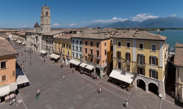 Visitors stroll through Desenzano del Garda on a sunny day with clear views of Lake Garda, showcasing the vibrant atmosphere in August