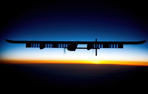 A high-altitude drone moves quietly in the twilight sky, its wings illuminated by sunset as stars start to shine above the Earth&rsquo;s curve
