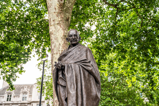 Bronze statue of Mahatma Gandhi by Philip Jackson (unveiled 2015), on a Portland stone base, Parliament Square, Westminster. Gandhi is depicted bare-legged, in a short cloak, London, UK.