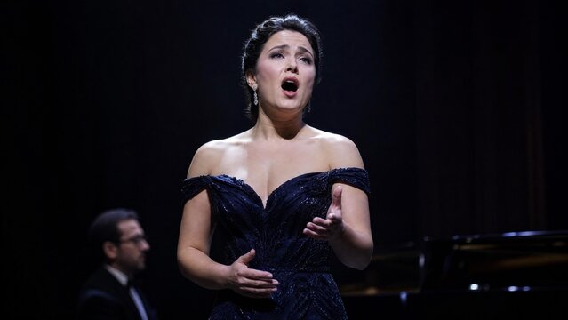 Beautiful Opera Singer Performing Aria on Stage in Elegant Evening Gown