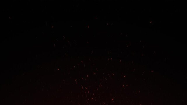Glowing orange fire sparks floating in darkness embers dark background ash particles embers dark background ash particles