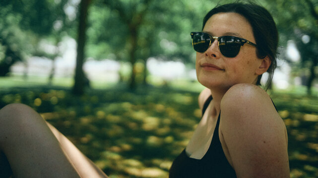 portrait of a young woman in sunglasses in the park