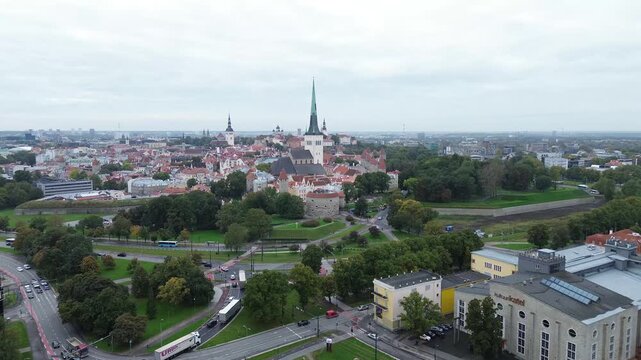 City skyline view of Tallinn with historic buildings and modern roads under cloudy skies