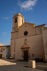 Fototapeta premium Epic ancient medieval stone church basilica facade bell tower sunset vertical view. 