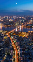 Obraz premium Aerial Night View of Illuminated City and Bridge.