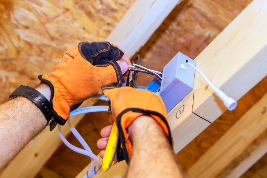 Working on electrical wiring inside building under construction