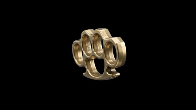 A solid golden brass knuckle duster floating diagonally against a dark black backdrop. Perfect for action movie teasers, street fight sequence overlays, crime thriller promos, and gaming weapon UI ass