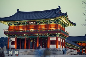 Obraz premium Front-side view of the illuminated Woljeonggyo Bridge gatehouse at dusk in Gyeongju.