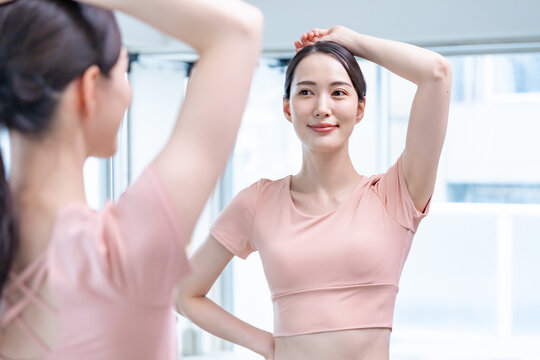 鏡でお腹をチェックする女性