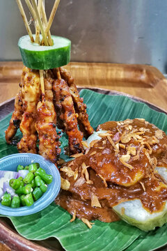 Authentic Indonesian chicken satay grilled over charcoal, served with rich peanut sauce, lontong rice cake, fried shallots and fresh chili on banana leaf.