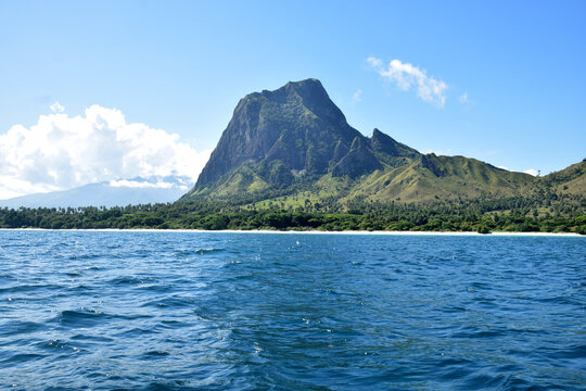 A beautiful view of a clear blue sky and stunning hills reminiscent of Jurassic Park on Nuca Molas Island, West Manggarai, Flores, Indonesia