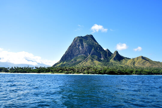 A beautiful view of a clear blue sky and stunning hills reminiscent of Jurassic Park on Nuca Molas Island, West Manggarai, Flores, Indonesia