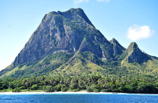 A beautiful view of a clear blue sky and stunning hills reminiscent of Jurassic Park on Nuca Molas Island, West Manggarai, Flores, Indonesia
