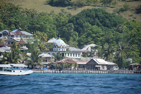 A beautiful view of a remote settlement amidst clear waters on Nuca Molas Island, West Manggarai, Flores, Indonesia