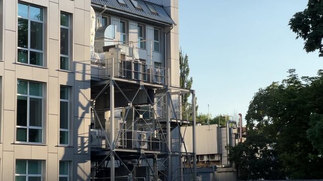 Modern Office Building Exterior with HVAC System | Industrial Ventilation Equipment on Steel Frame Structure | Panning Shot of Commercial Facility Rooftop Units