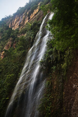 Obraz premium Vertical waterfall cascading down a cliff in Sumatra