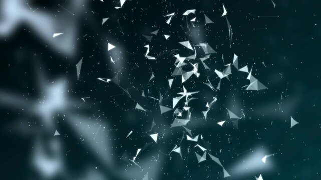 White particles exploding and dispersing in dark blue background footage