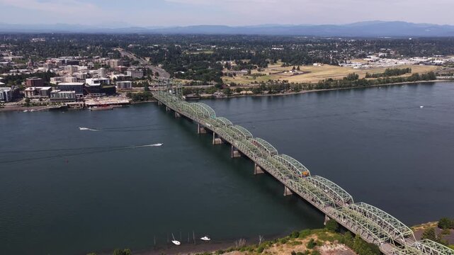 Aerial of Interstate 5 Bridge commercial corridor across Columbia River in Portland Oregon with truss bridge crossing Hayden Bay near Vancouver Washington
