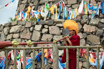 Obraz premium Lama monks blowing bronze horns on the Ovoo
