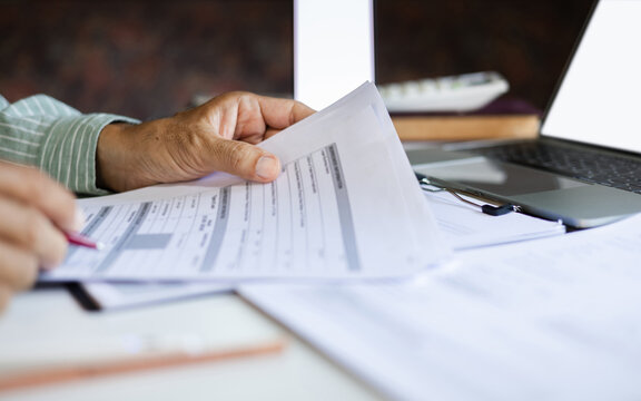 close-up shot, businessman work on desk reviewing business contract and verify the accuracy of the document