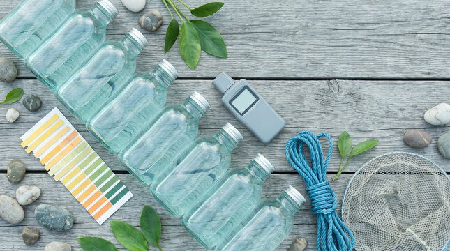 World Water Monitoring Day flat lay, glass sample bottles and water testing equipment on rustic wood, environmental conservation and ecology science background