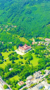Vertical video. Graz, Austria. Eggenberg Palace (Schloss Eggenberg) - the largest aristocratic residence in Styria is listed as a World Heritage Site. Construction was completed by 1646. Drone footag