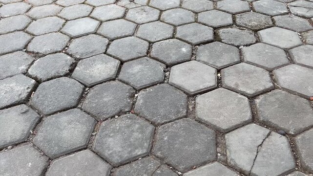 Medium close-up of hexagonal concrete paving blocks on outdoor ground