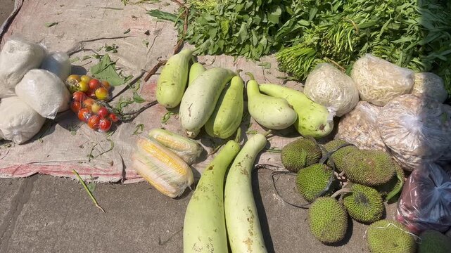 Assorted fresh tropical vegetables and breadfruit at Asian traditional market