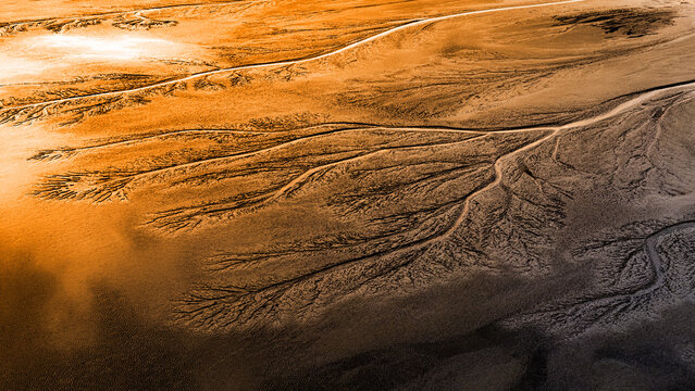 Sunset over the tidal tree patterns on the mudflats at the Qiantang River - aerial image
