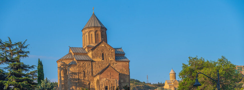 Ancient Metekhi church in old Tbilisi at golden hour with clean sky copy space