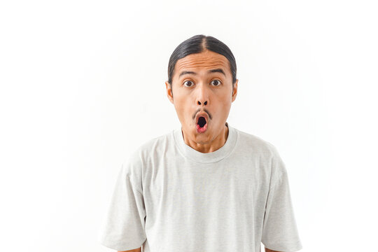 Surprised Asian man with wide open mouth looking at camera