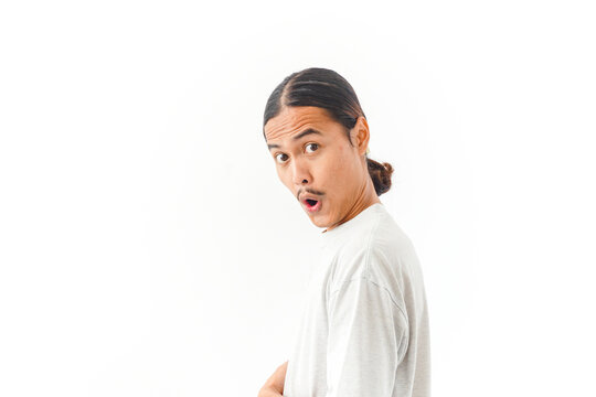 Surprised Asian man looking at camera with open mouth