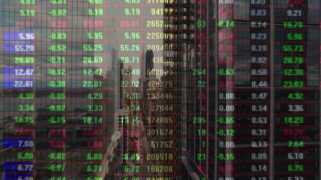 Dense grid of red and green stock market ticker numbers overlaid on modern urban architecture and city streets. Concept for fast-paced trading and global finance.