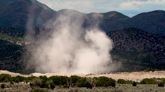 Dust devil blowing through gravel pit in the Utah desert in slow motion.