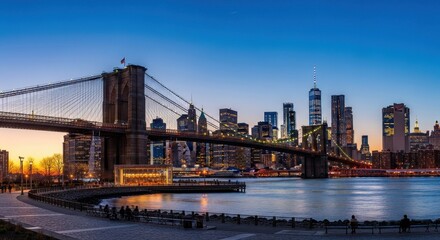 Obraz premium Brooklyn Bridge and New York City skyline at dusk.