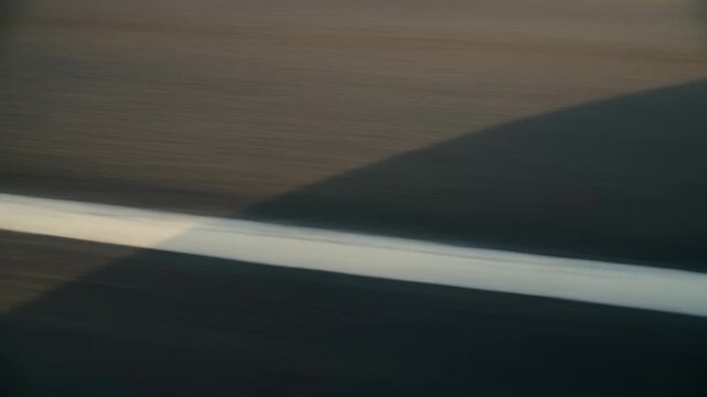 Logo static display, in background of a mountain range with a road, with digital graphic texture, from a static shot from a high angle perspective, with dark gray, white accents.