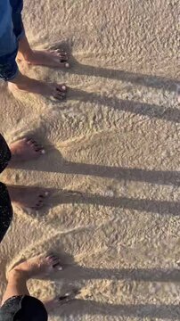 Friends' Feet Splashing Sea Water in Slow Motion, Beach Fun Together