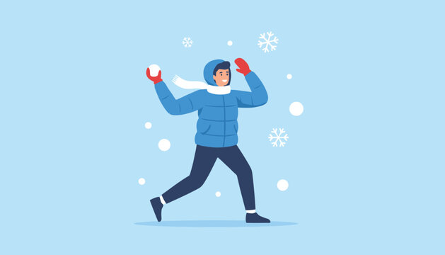 Cheerful young boy in a blue puffer jacket throwing a snowball while playing outdoors on a snowy winter day.