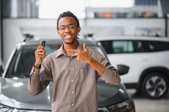 African american Man buying a car at a showroom
